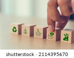 Small photo of Low carbon,carbon neutral concept. Net zero greenhouse gas emissions target. Climate neutral long term strategy. Hand put wooden cubes with decrease carbon emission icon and green icon. Green banner.