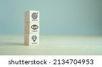 Small photo of Mission, vision and values of company. Purpose business concept. The wooden cube with mission, vision and values symbols on grey background, copy space. Modern stacking design. Business presentation.