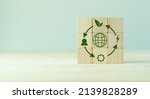 Small photo of Circular economy concept, recycle, environment, reuse, manufacturing, waste, consumer, resources. LCA Life cycle assessment. Sustainability Wooden cubes; symbol of circular economy on grey background.