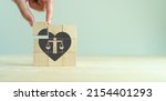 Small photo of Ethical corporate culture concept. Ethics inside human heart. Business integrity and moral. Placing wooden cubes with ethics inside a heart on smart background. Sustainable business development.