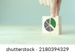 Small photo of Growing green business market concept. Increase market share, growth of business profit. Market penetration and expansion strategies. Wooden cubes showing a market share percentage using a pie chart.