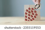 Small photo of Customer engagement, increasing customer loyalty concept. Building relationships, increase brand awareness, and drive sales. Wooden cube blocks with red hearts and customer loyalty icon on background.
