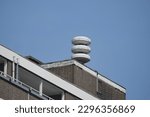 Small photo of Pole with Dutch acoustic air alarm system aka air raid siren alert also known as luchtalarm in Dutch above building in Holland city center used to warn public for example during war or attack