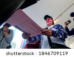 Small photo of First time voter Salvadora Maria Roxanna, 73, casts her ballot at a vote center in Dodgers Stadium during the election day in Los Angeles, Tuesday, Nov. 3, 2020.