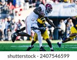 Small photo of Alabama quarterback Jalen Milroe #4 is brought down by Michigan defensive back Mike Sainristil #0 during the 2024 Rose Bowl game Monday, Jan. 1, 2024, in Pasadena, Calif.