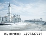 Snowy winter landscape with historical building of city hall of Mogilev, Belarus. Central city square on the embankment of river Dnepr