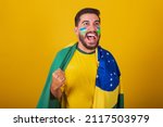 Small photo of Brazilian man, latin american, cheering for brazil, in the world cup 2022, fan, brunette, celebrating, vibrating, happy screaming goal, handsome.