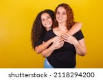 Small photo of Grandmother and niece, Brazilian, Latin American, curls, afro hair, curly, smiling, hugging, family photo, beautiful. Mother's Day, Fraternity, Love.