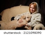 Woman Lies With A Large Dog On...