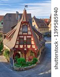 Small photo of Beautiful view of the historic Gerlach Blacksmith shop and the Roeder Gate Tower in the medieval town Rothenburg ob der Taube on a sunny day, Bavaria, Germany