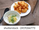 Small photo of rice gruel in bowl on tablecloth in morning