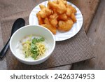 Small photo of rice gruel in bowl on tablecloth in morning