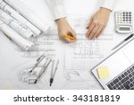 Architect working on blueprint. Architects workplace - architectural project, blueprints, ruler, calculator, laptop and divider compass. Construction concept. Engineering tools. Top view