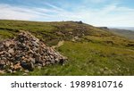 A conical mound of rocks acts as a traditional marker for walkers following the route on the edge of Kinder Scout.