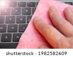 hand wipes laptop keyboard with ... | Shutterstock . vector #1982582609