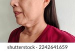 Small photo of portrait the flabbiness adipose hanging skin, cellulite and flabby skin under the neck, the mole on the body, wattle and cellulite under the chin of Middle-aged woman, health care and medical concept.