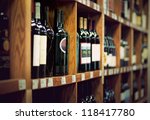 Wine Bottles On Wooden Shelf In ...