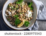 Small photo of Healthy Salad made from Quinoa, Cucumber, Herbs, Pistachios, Chickpeas and Feta with lemon juice and olive oil. So called Jennifer Aniston Salad, fresh, crunchy, and packed with plant-based protein