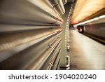 Image of an empty metro station with a departing train. Perspective, blurred background, no people, focus on wall decoration.