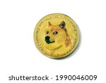 Cryptocurrency Dogecoin, a gold coin with a dog of the siba inu breed in close-up on a white background isolated