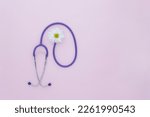 Small photo of Stethoscope, white flower on pink background with copy space. Medical flat lay. International Nurse's Day. International Women's Day. March 8th. creative