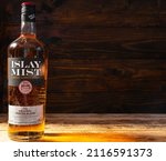 Small photo of Bottle of Islay Mist Original Scotch Whisky on a wooden background. The taste of whisky is dominated by peaty and tarry accents, softened by a complex composition Russia, Krasnodar, December 11, 2021