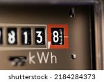 Close-up electricity meter. Analog gauge for households. Measuring the electricity consumed in kWh (kilowatt hours)