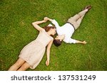 Couple Laying On The Grass