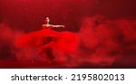 Small photo of young graceful ballerina, dressed in pointe shoes and a weightless red skirt, demonstrates her dancing skills. The beauty of classical ballet.