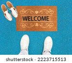 Welcome door Mat placed with Shoes and Ladies Sandles
