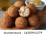 Small photo of Bitterballen are a Dutch meat-based snack, made by making a very thick stew thickened with roux and beef stock and generously loaded with meat.