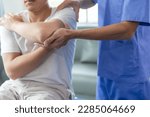 Small photo of Doctor or Physiotherapist working examining treating injured arm of athlete male patient, stretching and exercise, Doing the Rehabilitation therapy pain in clinic.