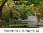 Small photo of The national flag of Greece is waving in the clear blue Greek sky. The white cross symbolises Eastern Orthodox Christianity, the prevailing religion of Greece. Drama city. Greece.