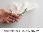 Small photo of Dressing or clean wound tools includes Roll gauze,pile of gauzes and gauze roll cutter or scissors with Hand cut gauze