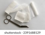 Small photo of Dressing or clean wound tools includes Roll gauze,pile of gauzes and gauze roll cutter or scissors