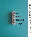 Small photo of DJIA Dow Jones industrial average symbol. Concept words DJIA Dow Jones industrial average on wooden cubes on beautiful blue background. Business DJIA Dow Jones industrial average concept. Copy space