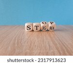 Small photo of Stop stigma symbol. Doctor turns cubes with words stop stigma. Beautiful blue background. Medical and stop stigma concept. Copy space.