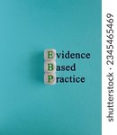 Small photo of Green words EBP Evidence-based practice concept on wooden cubes. Beautiful blue background. Business concept.