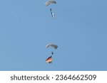 Small photo of Military paratrooper with the flag of Germany in the sky, ILA Berlin Air Show, BERLIN, GERMANY - APR 27, 2018