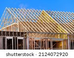 New residential construction home framing against a blue sky roofing construction wood sky trusses