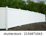 White vinyl fence fencing of private property grass plastic