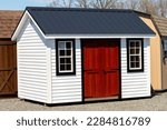 new wood sheds on display the shed is typically used as outdoor storage and commonly located in home backyard store grey front