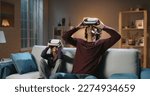 Small photo of Future is now. Funny south asian siblings or father and son with curly hair are trying virtual reality headsets, having fun playing video games - modern technologies, family time concept