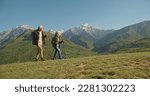 Small photo of Mature caucasian couple on vacation, having a hike in spring mountains, spending time together after retirement together travelling - tourism, pension concept