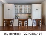 white and glazed kitchen cabinet, with wooden kitchen table and chairs

