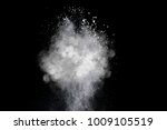 Freeze motion of heart shaped powder isolated on black background. Abstract design of dust cloud. Particles explosion screen saver, wallpaper with copy space. Love, passion, feelings concept
