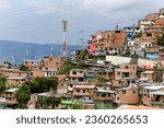 Small photo of Medellin, Colombia - Apr 16, 2022: Colorful streets of Comuna 13 district in Medellin, Colombia, a former crime ridden neighborhood.