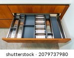 Modern kitchen, Open drawers, Set of cutlery in kitchen drawer. Utensil divider for drawers.