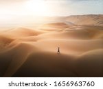 Woman Walking On The Desert...