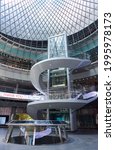 Small photo of New York, NY - June 17, 2021: The cork-screw stairway of the Fulton Center in Lower Manhattan, NYC surrounds a glass elevator. Fulton Center is a subway hub and retail complex